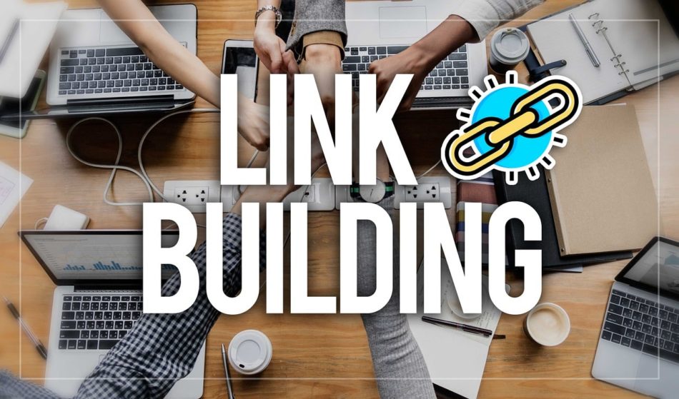 Team hands over a desk with laptops and the words link building